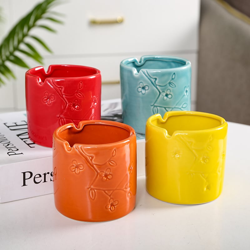 Four Ceramic Ashtrays In Red Orange Blue Yellow