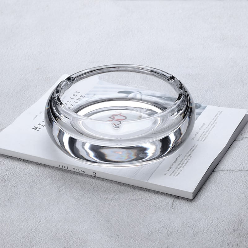 Round Crystal Glass Ashtray transparent on book