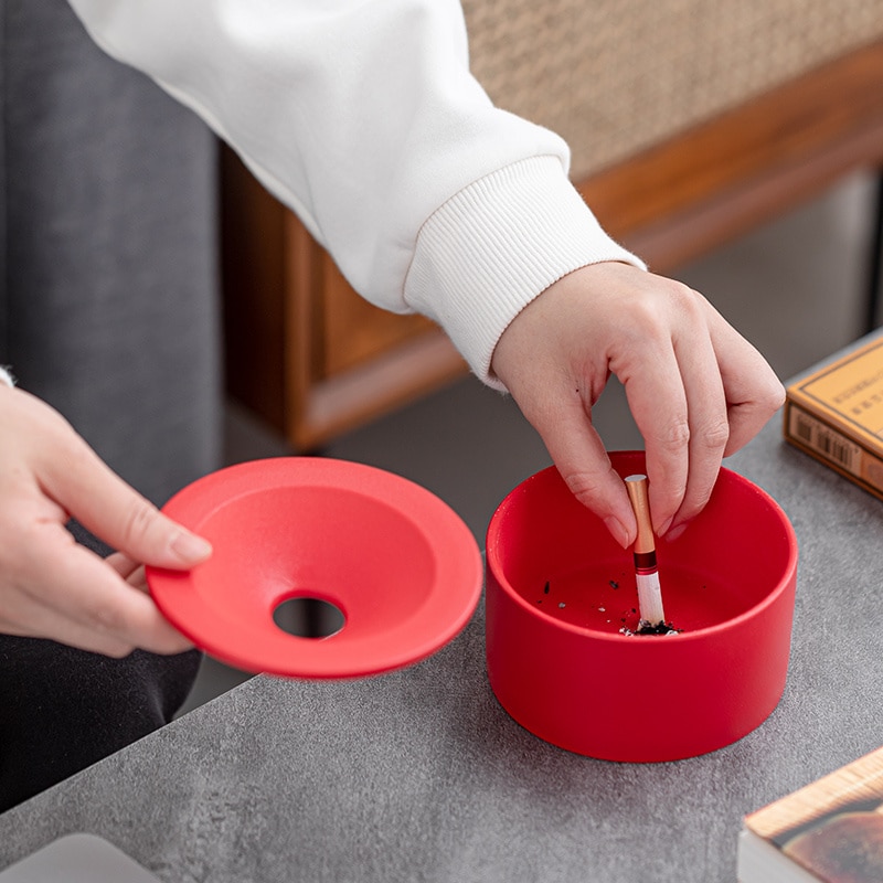 Stubbing Out A Cigarette Using Red Ashtray