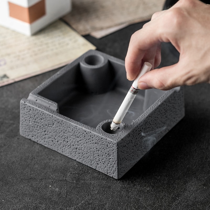 Stubbing Out Cigarette Using Cement Ashtray